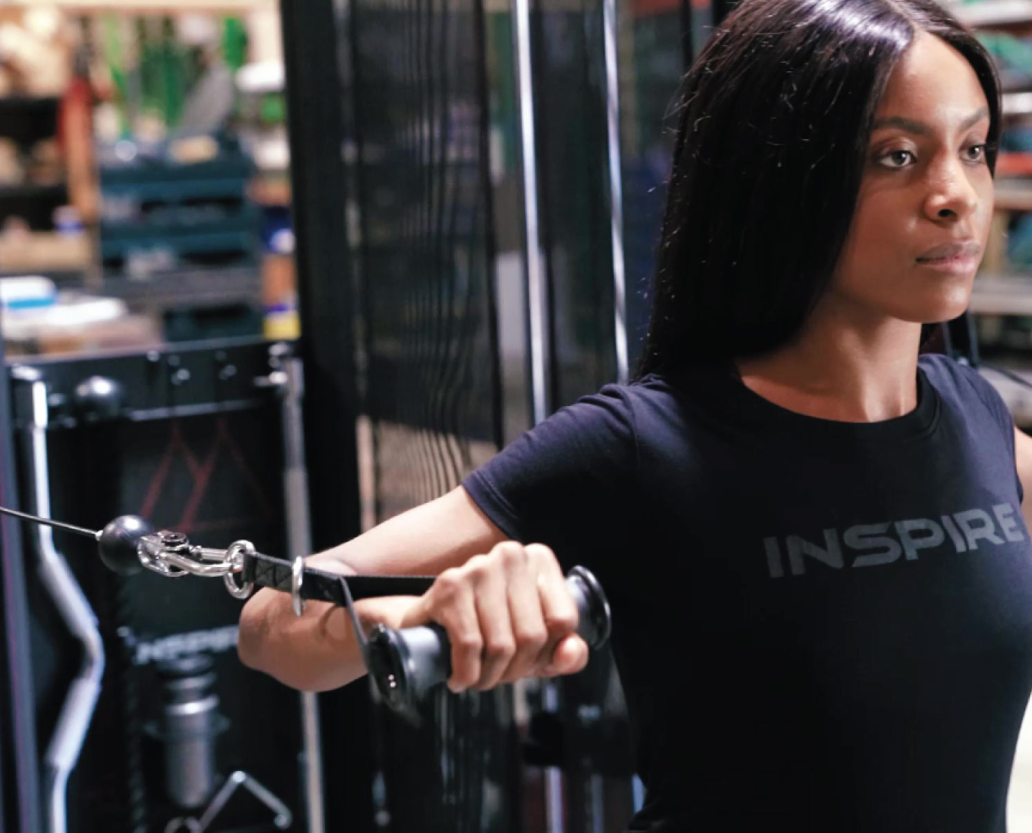 Woman working out with the CFT Commercial Functional Trainer by Inspire Fitness